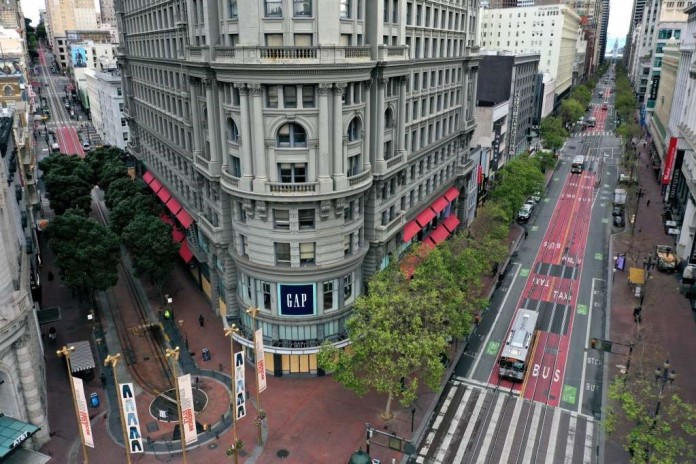 Market St, arguably the busiest street in San Francisco, shown deserted during the beginning of Bay Area lockdown in March (source: SFGate)
