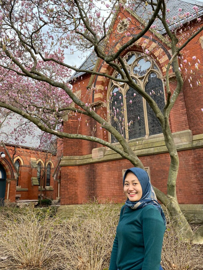 Raisa posed in front of a blossoming cherry tree in Cornell University.