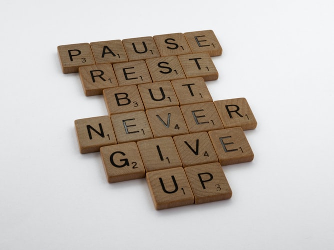 A wooden block puzzle with the motivating words 