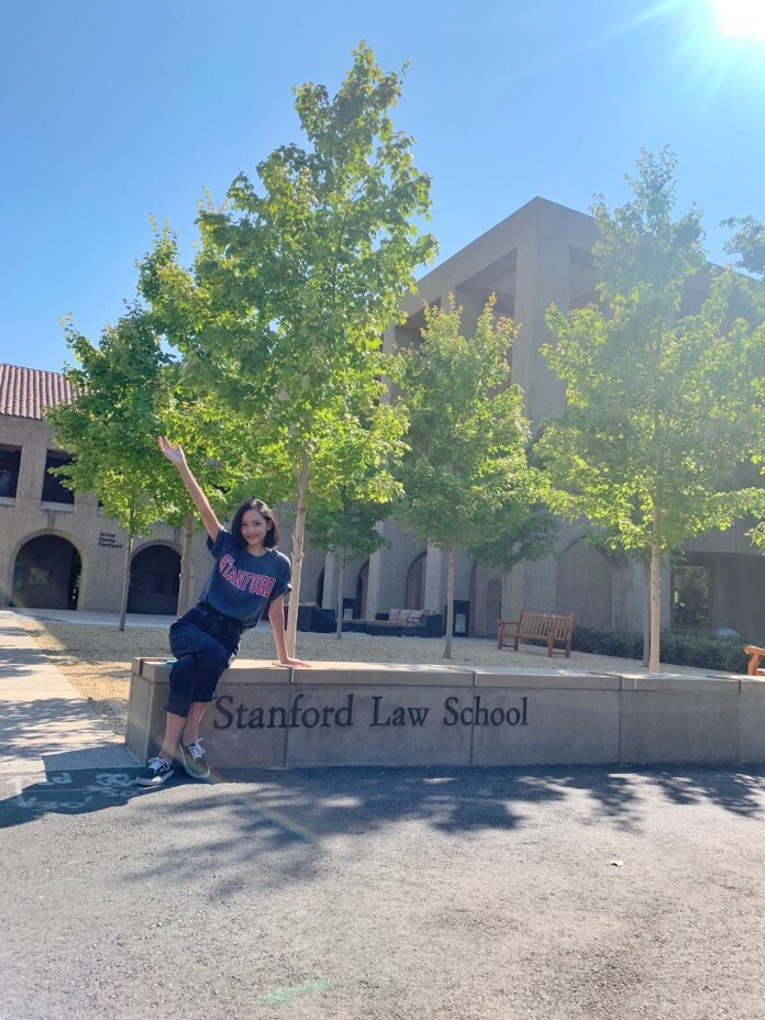 Nadira stood before Stanford Law School's signage.