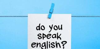 Do You Speak English Written On White Paper Hanging On Blue Background With the Latch