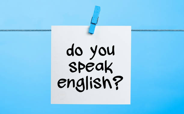 Do You Speak English Written On White Paper Hanging On Blue Background With the Latch